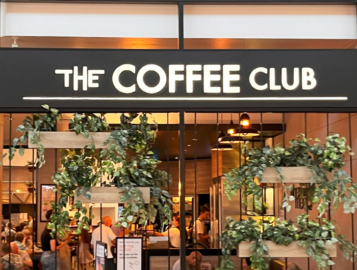 Front-lit fabricated shopfront letters with clear letter spacing and open counters on a black fascia